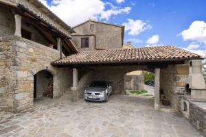 a car is parked in a stone garage at House Vera in Hum