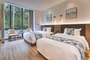 Voodi või voodid majutusasutuse Guangdong Hot Spring Hotel toas