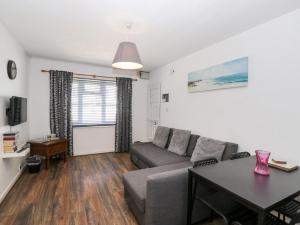 a living room with a couch and a table at Ocean Breeze in Burnham on Sea