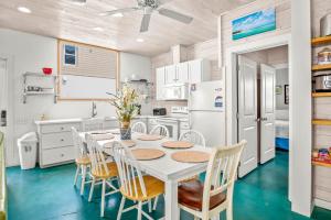 a kitchen with a white table and chairs at 7 Heaven in Port Aransas