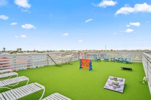 a balcony with chairs and a table on a roof at 7 Heaven in Port Aransas