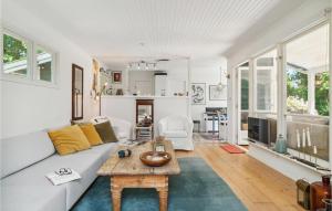 a living room with a couch and a table at 3 Bedroom Lovely Home In Gilleleje in Gilleleje