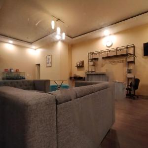 a living room with a couch and a table at RB Room Bogorienze The Jungle Bogor in Bogor +52 photos