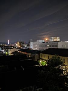 a city skyline at night with buildings at Guest House Kyoto Inn in Kyoto +63 photos