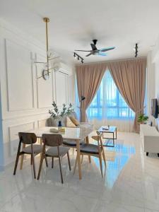 a white living room with a table and chairs at #Netflix #Cuckoo Troika Kota Bharu Homestay 0118 in Kota Bharu