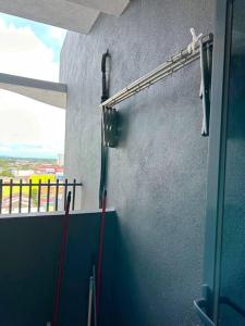 a room with a wall with a hose on a wall at #Netflix #Cuckoo Troika Kota Bharu Homestay 0118 in Kota Bharu