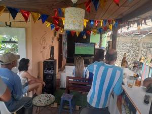 a group of people sitting in a room with a television at Matilda Ec in Vilcabamba +39 photos