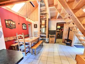 a dining room with a wooden table and wooden stairs at Grand Appartement Confortable 10/12 Pers, Terrasse, Parking - FR-1-267-250 in Villarembert +17 photos