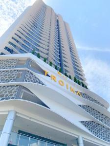 a tall building with a sign on the side of it at Netflix 2 Bedroom Troika Kota Bharu Homestay 1812 in Kota Bharu