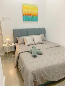 a bed with a blue headboard in a bedroom at Netflix 2 Bedroom Troika Kota Bharu Homestay 1812 in Kota Bharu +41 photos