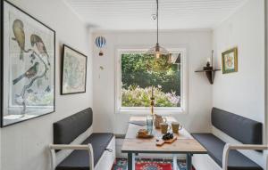 a dining room with a table and chairs and a window at 3 Bedroom Lovely Home In Gilleleje in Gilleleje