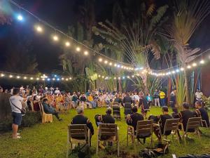 a crowd of people sitting in chairs at an event at Trung Nguyên Coffee Resort in Buon Ma Thuot