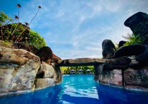 a pool at a resort with blue water at Try Palace Resort Kep in Kep