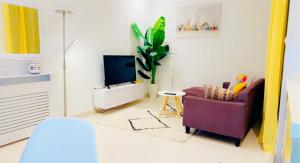 a living room with a couch and a tv at Sweet home in Dakar