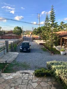 a car parked in a gravel parking lot at Casa Santa Paz - Gravata, próximo ao Centro in Gravatá