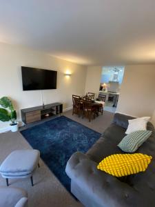 a living room with a couch and a flat screen tv at David’s apartment in London