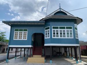 a blue building with a staircase in front of it at Sri Cengal Homestay in Kuala Terengganu