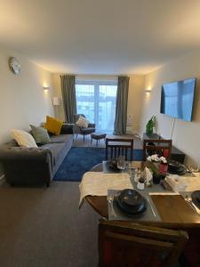 a living room with a couch and a table at David’s apartment in London