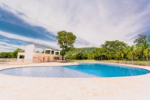 a large swimming pool in front of a building at Apartasol Dominica Citadela Di Sole in Santa Fe de Antioquia