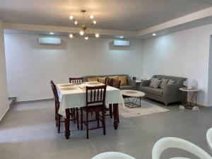 a dining room with a table and a couch at Mia's House in Puerto Peñasco