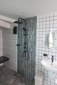 a bathroom with a shower and a sink at Miami Seaview in Ban Pak Ba Ra