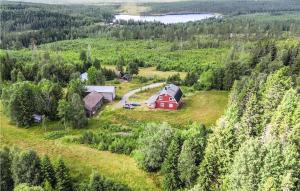 an aerial view of a red barn on a green field at 3 Bedroom Awesome Home In Nybofjll 