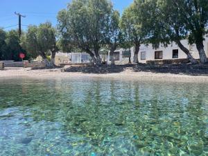 a body of water with a house in the background at Seascape Krithoni in Agia Marina