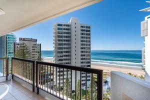 a balcony with a view of the beach and buildings at Longbeach Luxe, Surfers Paradise in Gold Coast