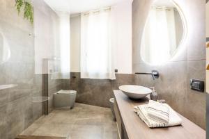 a bathroom with a sink and a toilet at Panoramic Private Parking Elegant Apartment in Aci Castello