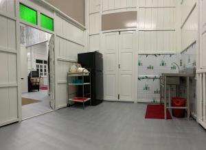 a room with white walls and a room with green windows at Sri Cengal Homestay in Kuala Terengganu +1 photo