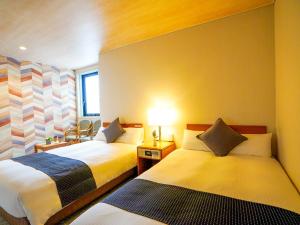 Postel nebo postele na pokoji v ubytování Hotel New Gaea Itoshima