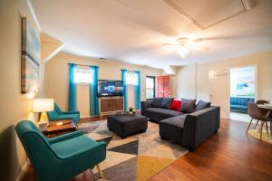 a living room with a couch and chairs at The Mid-Century Hub Close to Everything in Columbia