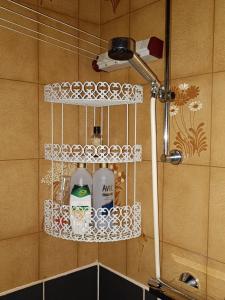 a shower rack with three bottles on a wall at Ristiina Apartment with Sauna in Ristiina