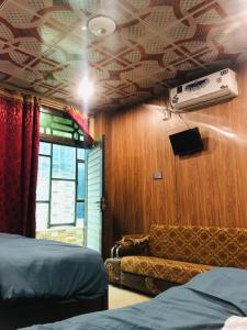a room with a bed and a couch at Zara Residence 1 in Swat