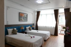 Voodi või voodid majutusasutuse Maison d'Hanoi Hotel toas