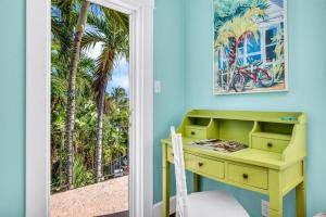 een geel bureau in een kamer met een raam bij Resort-style Estate w/ Pvt Guest Suites- Sleeps 15 in West Palm Beach