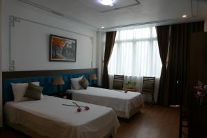 Voodi või voodid majutusasutuse Maison d'Hanoi Hotel toas
