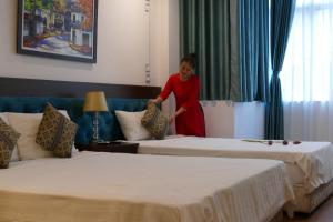 Voodi või voodid majutusasutuse Maison d'Hanoi Hotel toas