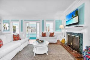 a living room with a white couch and a fireplace at Resort-style Estate w/ Pvt Guest Suites- Sleeps 15 in West Palm Beach