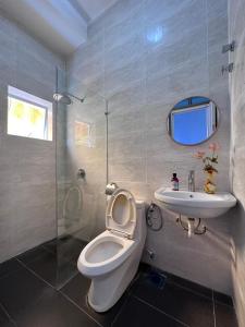 a bathroom with a toilet and a sink at Ipoh Cozy Lake View Homestay in Lahat