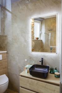 a bathroom with a sink and a mirror at PORT - unique apartment in Dubrovnik