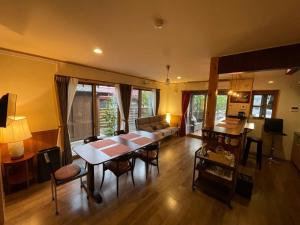 a living room with a table and a couch at Villa Sense of wonder in Takayama