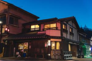 un edificio con un negozio in una strada di notte di 竹田まちホテル a Taketa