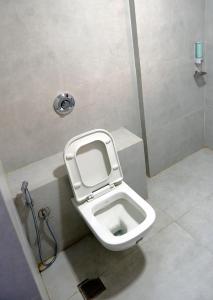 a bathroom with a toilet in a stall at Hotel Kewal in Nashik