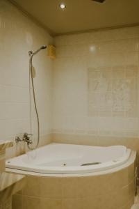 a bath tub in a bathroom with a shower at Pepy's home in Kavala