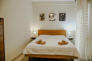 a bedroom with a bed with two towels on it at Pepy's home in Kavala