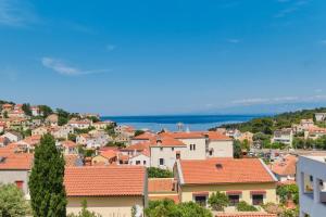 a view of a town with orange roofs at Sea View Apartment Sandra in Mali Lošinj in Mali Lošinj