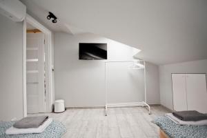 a white room with a tv on the wall at Spokojna Apartamenty in Trzebinia