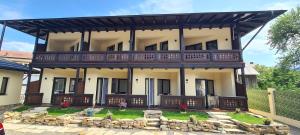 a large house with a balcony on top of it at Fexada Home in Vama