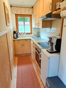 a kitchen with a sink and a stove top oven at Chalet Faschingalm in Debant